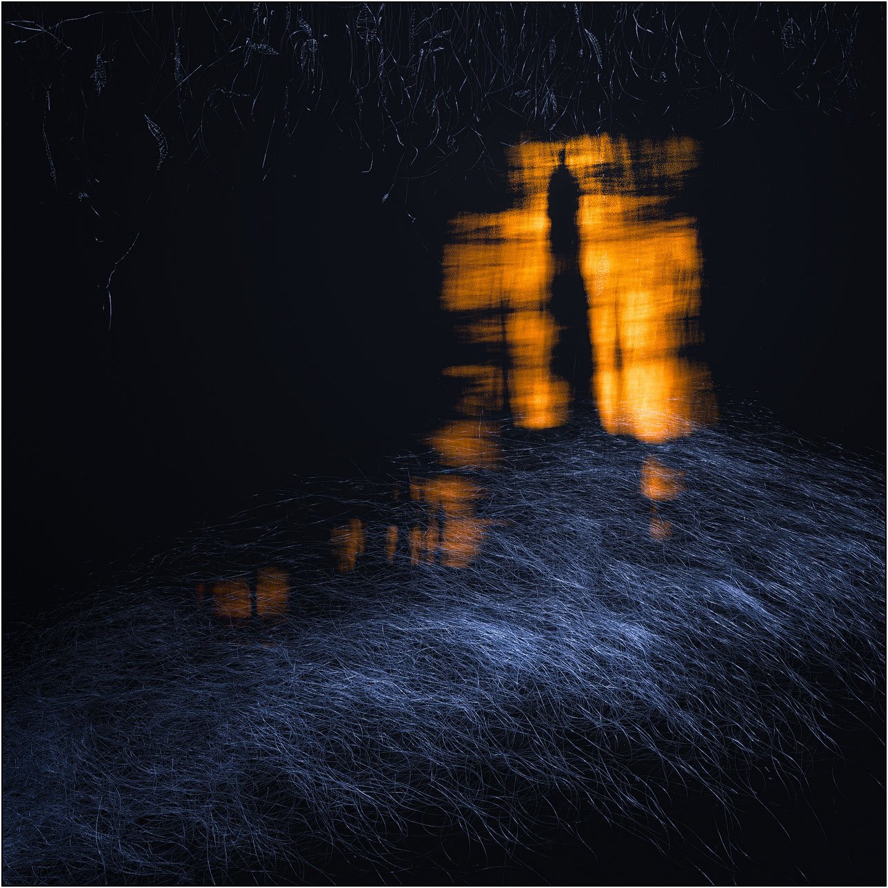 Fiber art installation with reflected light and abstract textures in blue and gold.