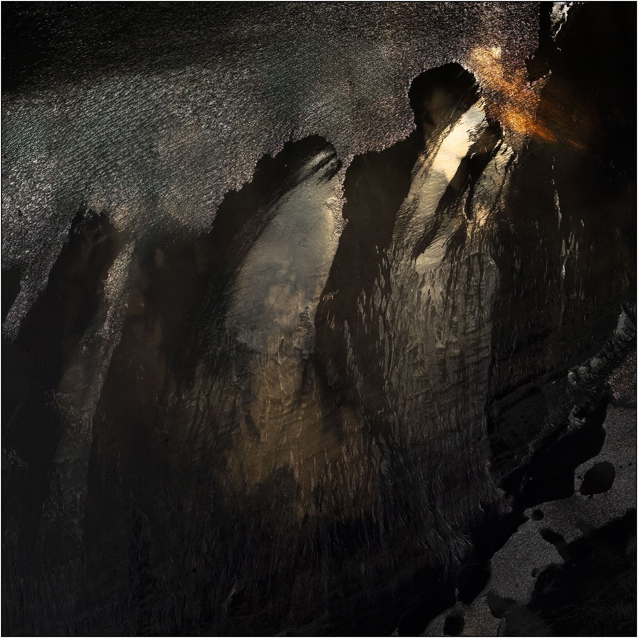 Abstract aerial composition with dramatic contrast and flowing textures evoking a dark, painterly scene