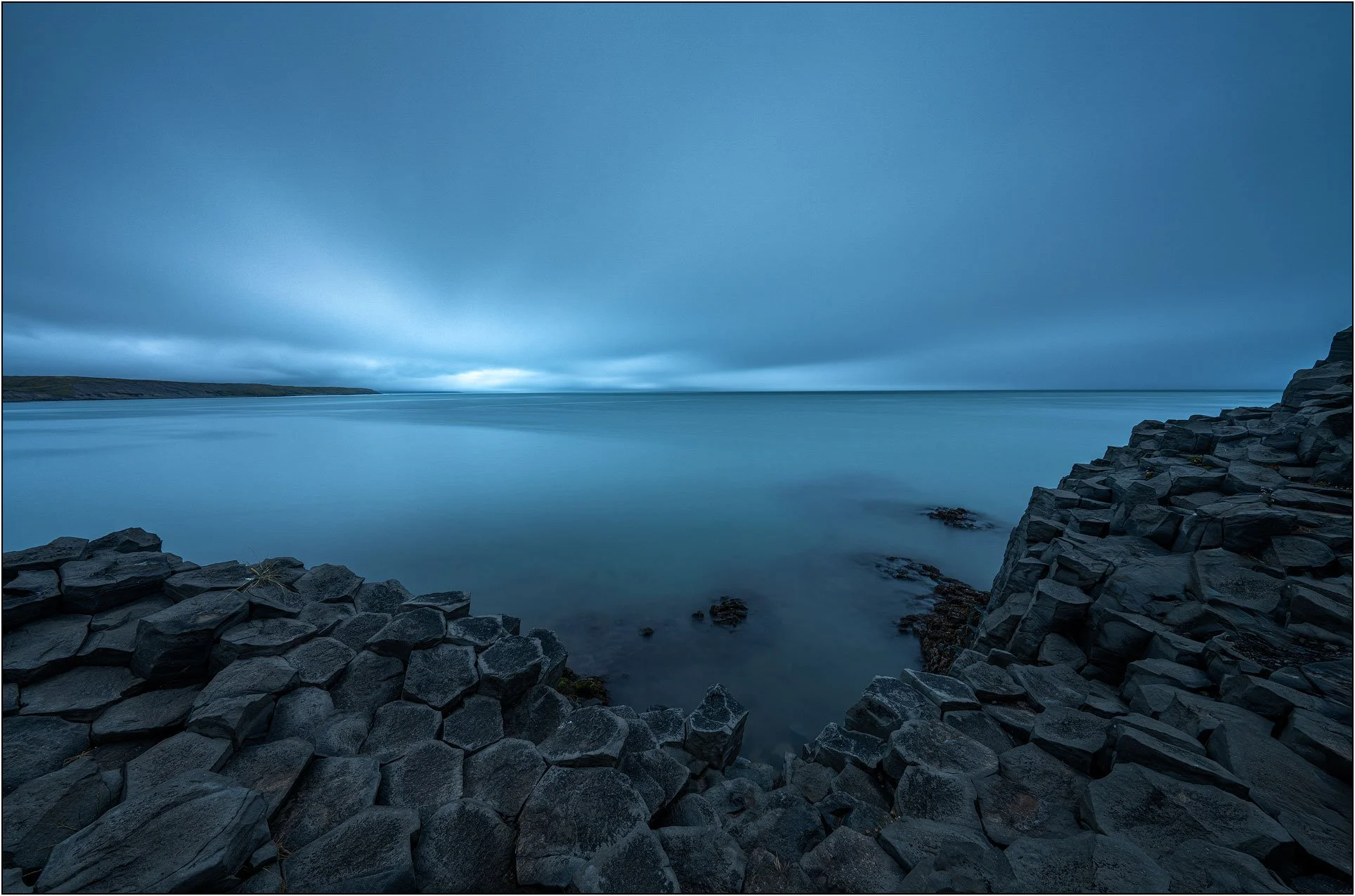 Long exposure image of Basalt columns by the ocean in Iceland, creating soft and dreamy effect.