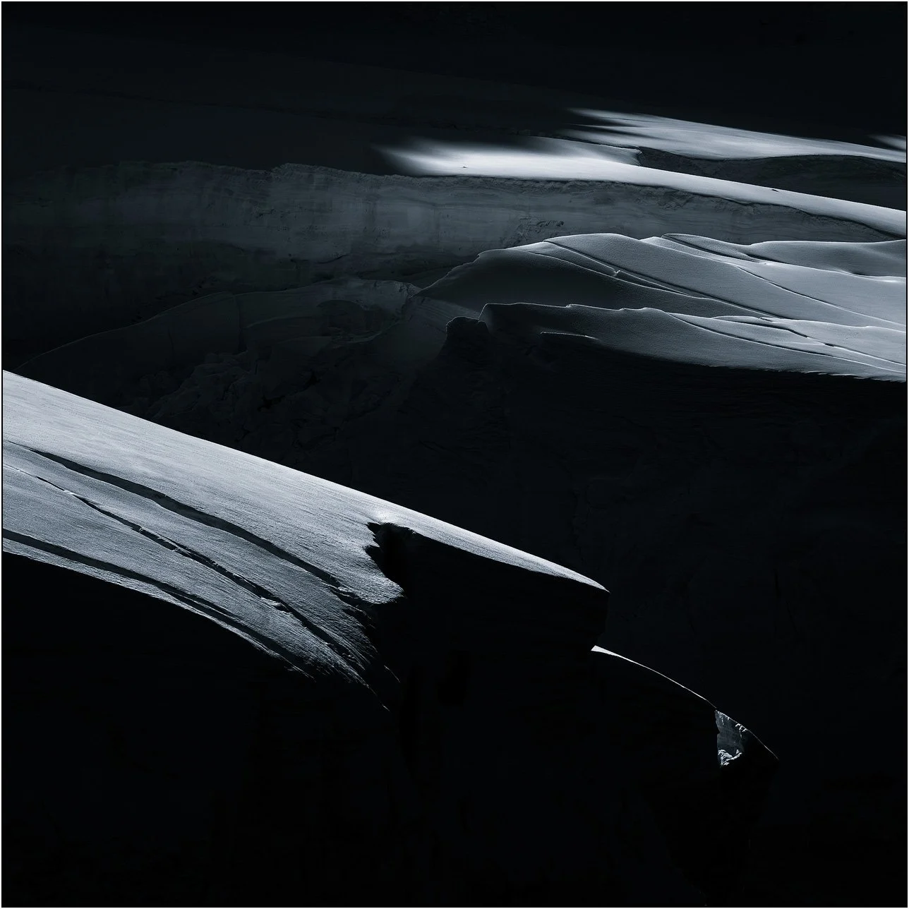 Crevassed ice under dramatic light in Antarctica.