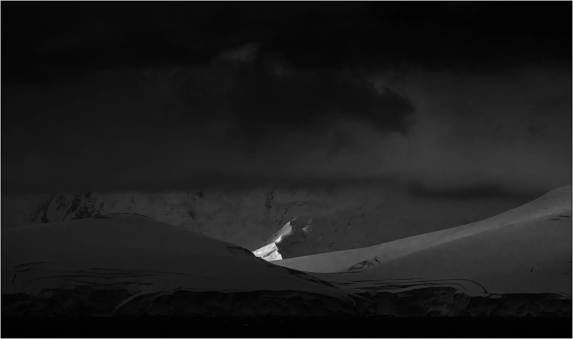 Spotlight on a slope of mountains in Antarctica peninsula.