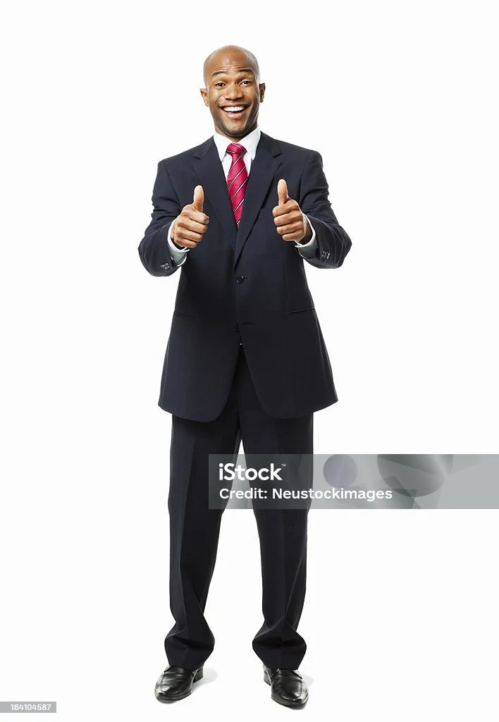 A smiling man in a business suit giving two thumbs up.