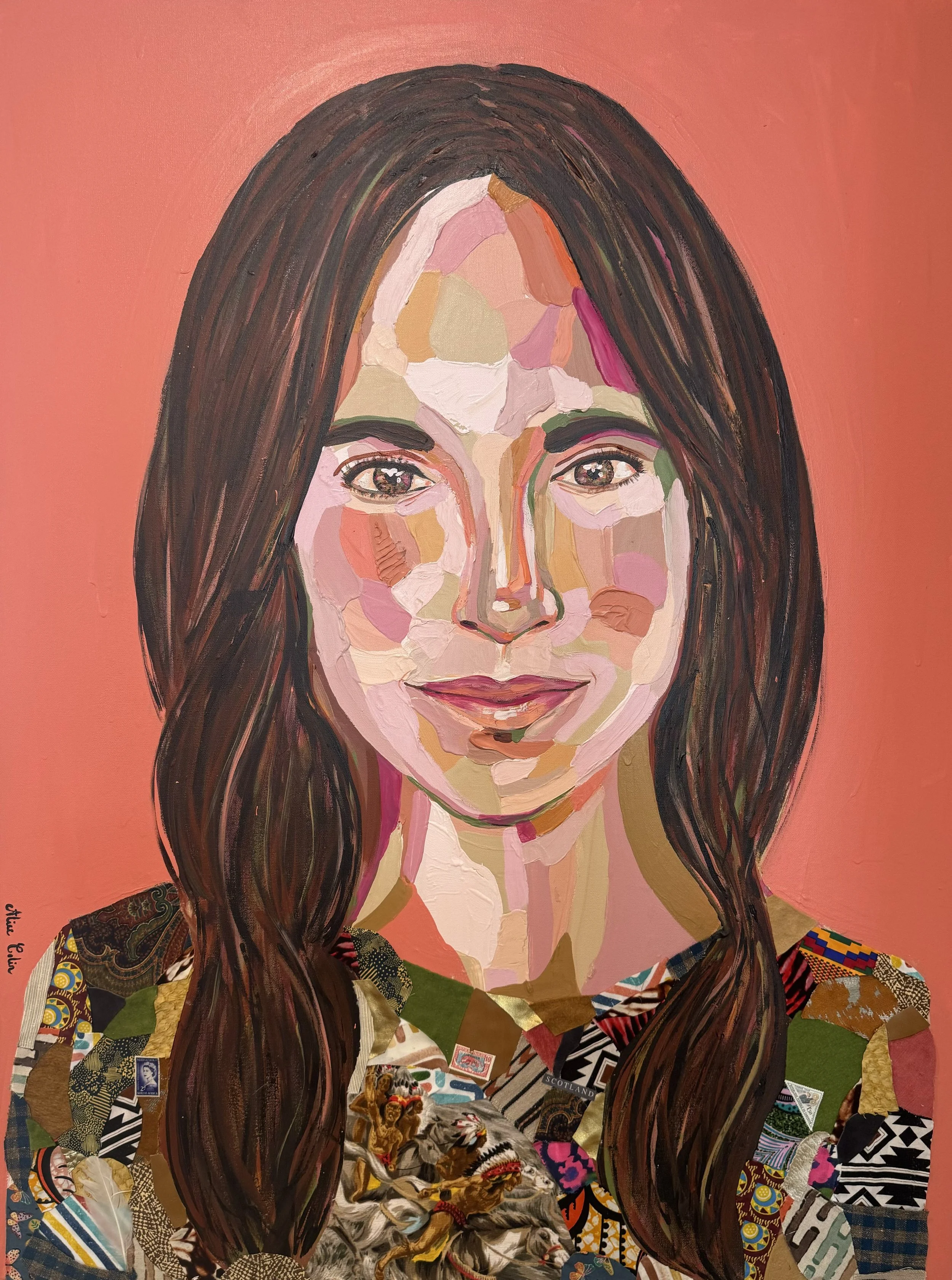 A portrait of a woman painted with collage paper and paint, featuring long dark hair, a subtle smile, and wearing a multicolored patchwork dress, set against a warm peach background.
