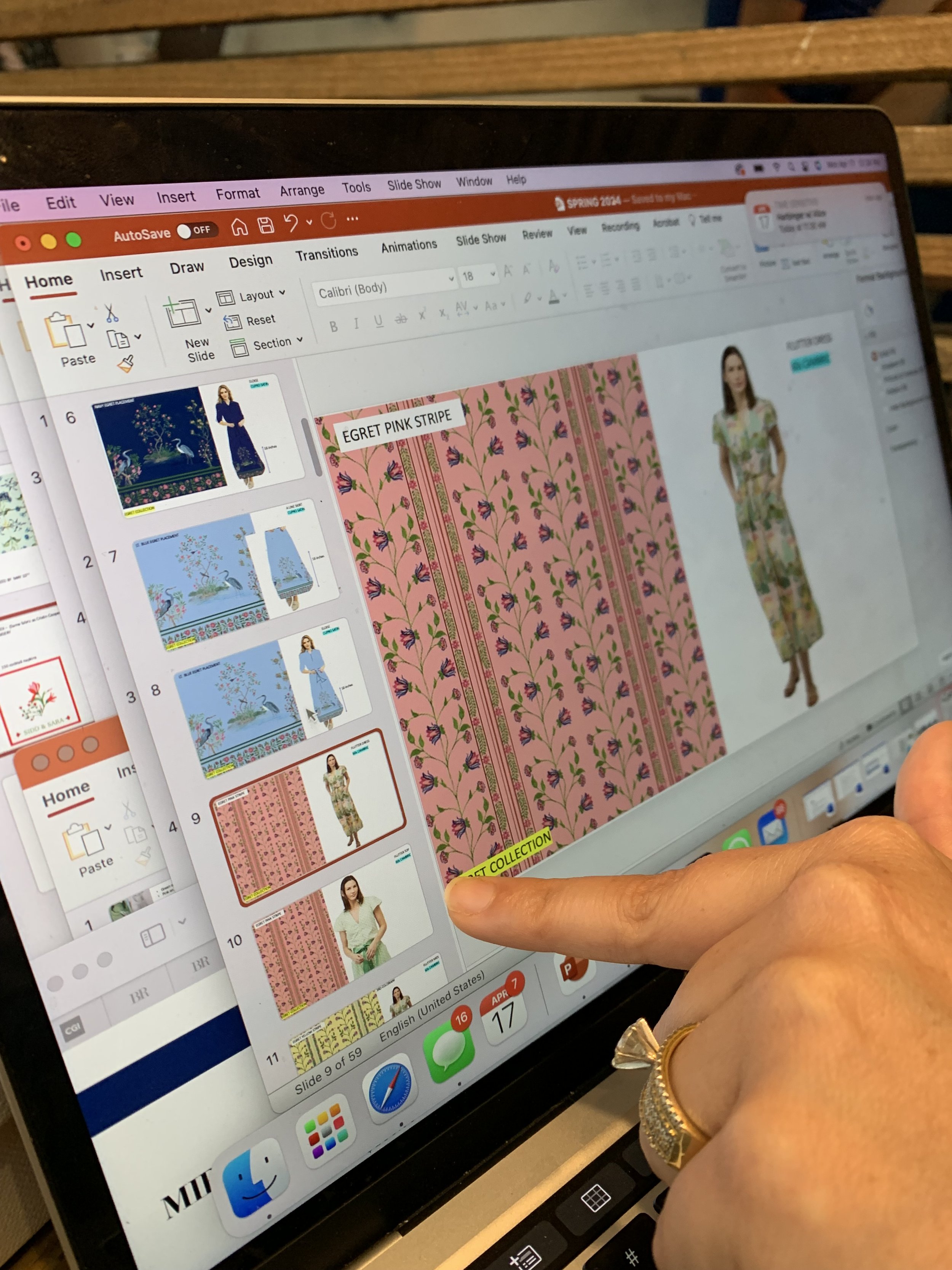 A person using a laptop to create a PowerPoint presentation with fabric pattern samples and a model dressed in different outfits.