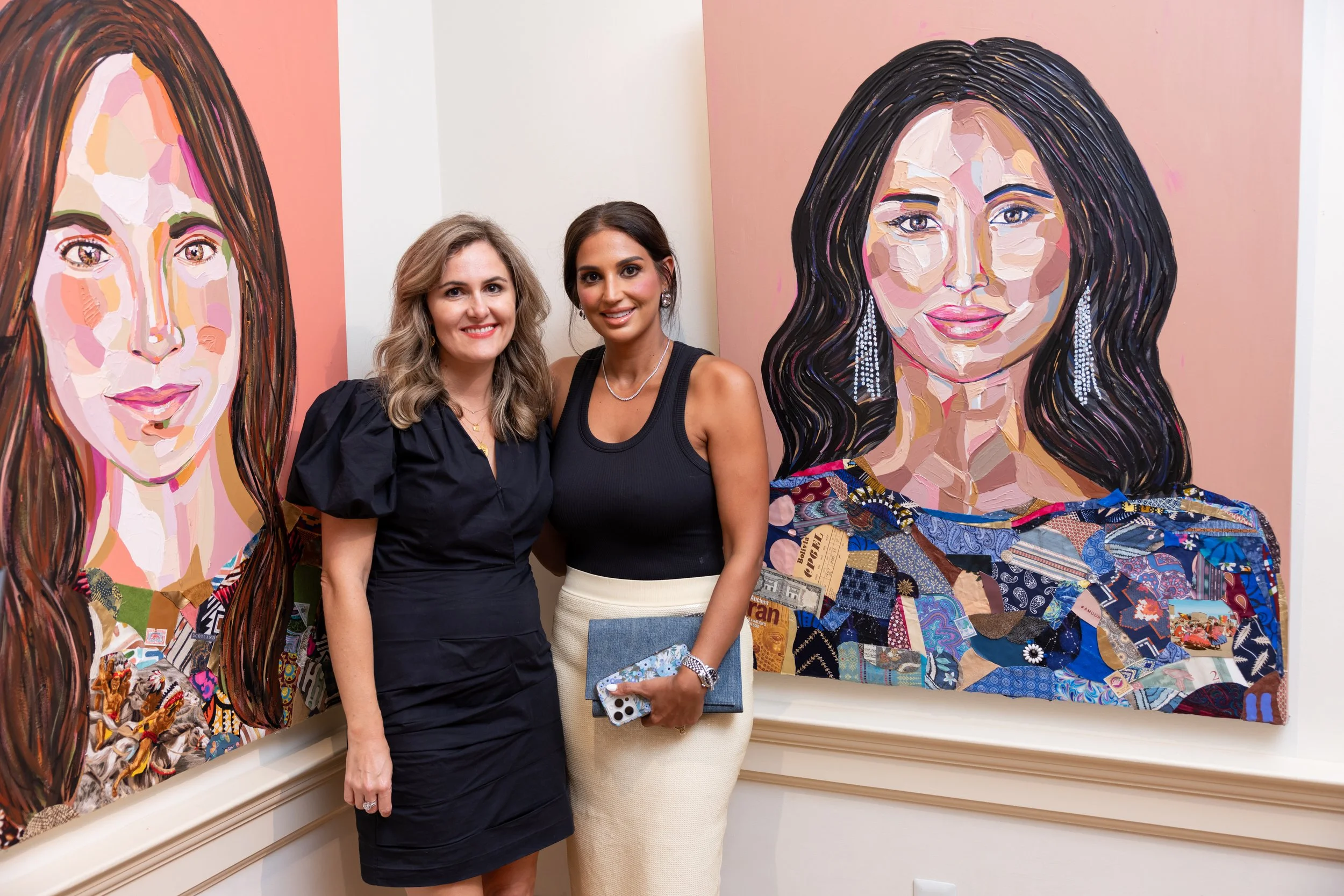 Two women standing in front of colorful abstract portrait paintings in an art gallery.