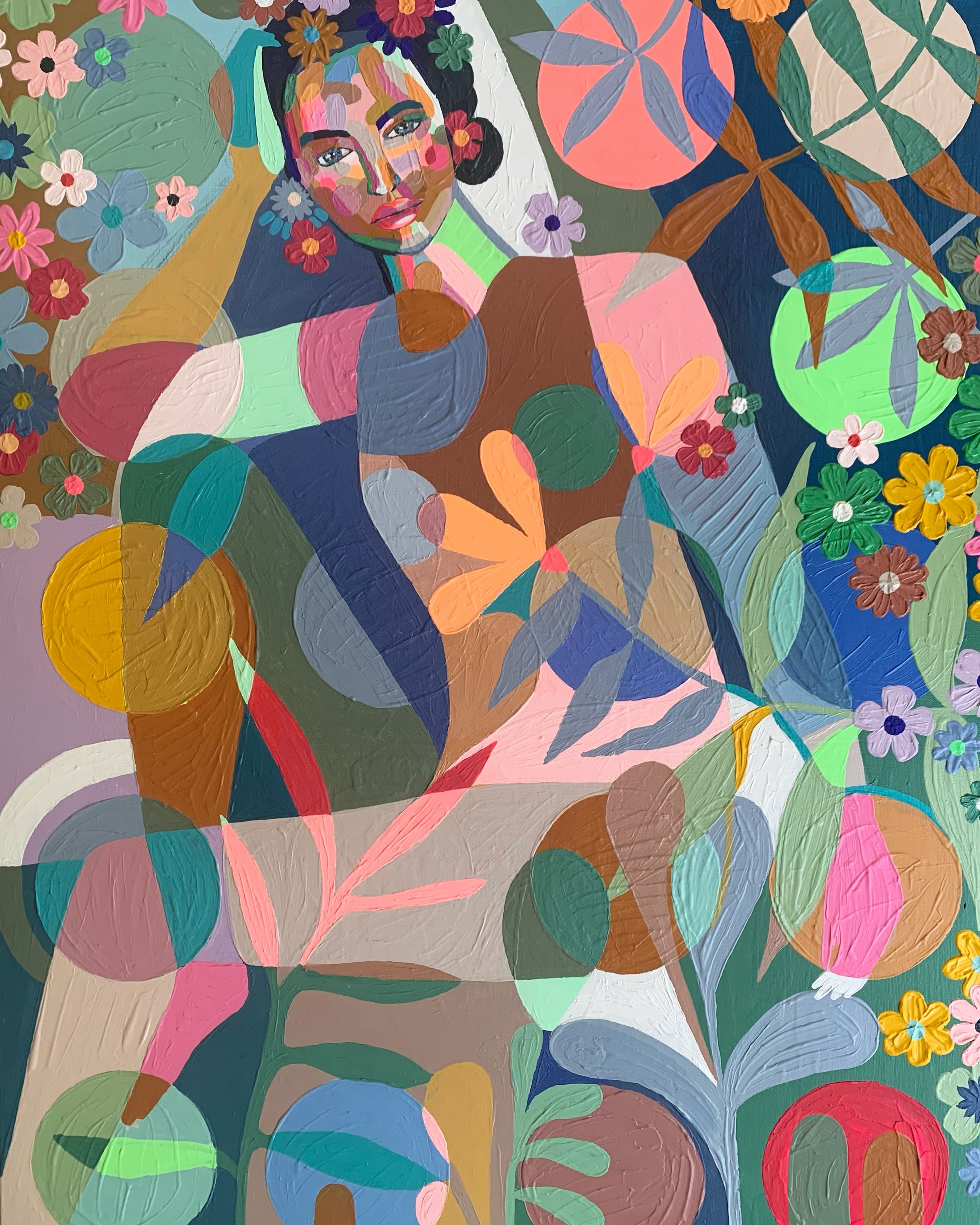 Colorful abstract painting featuring a woman with dark hair, surrounded by vibrant flowers, leaves, and geometric shapes in various colors.