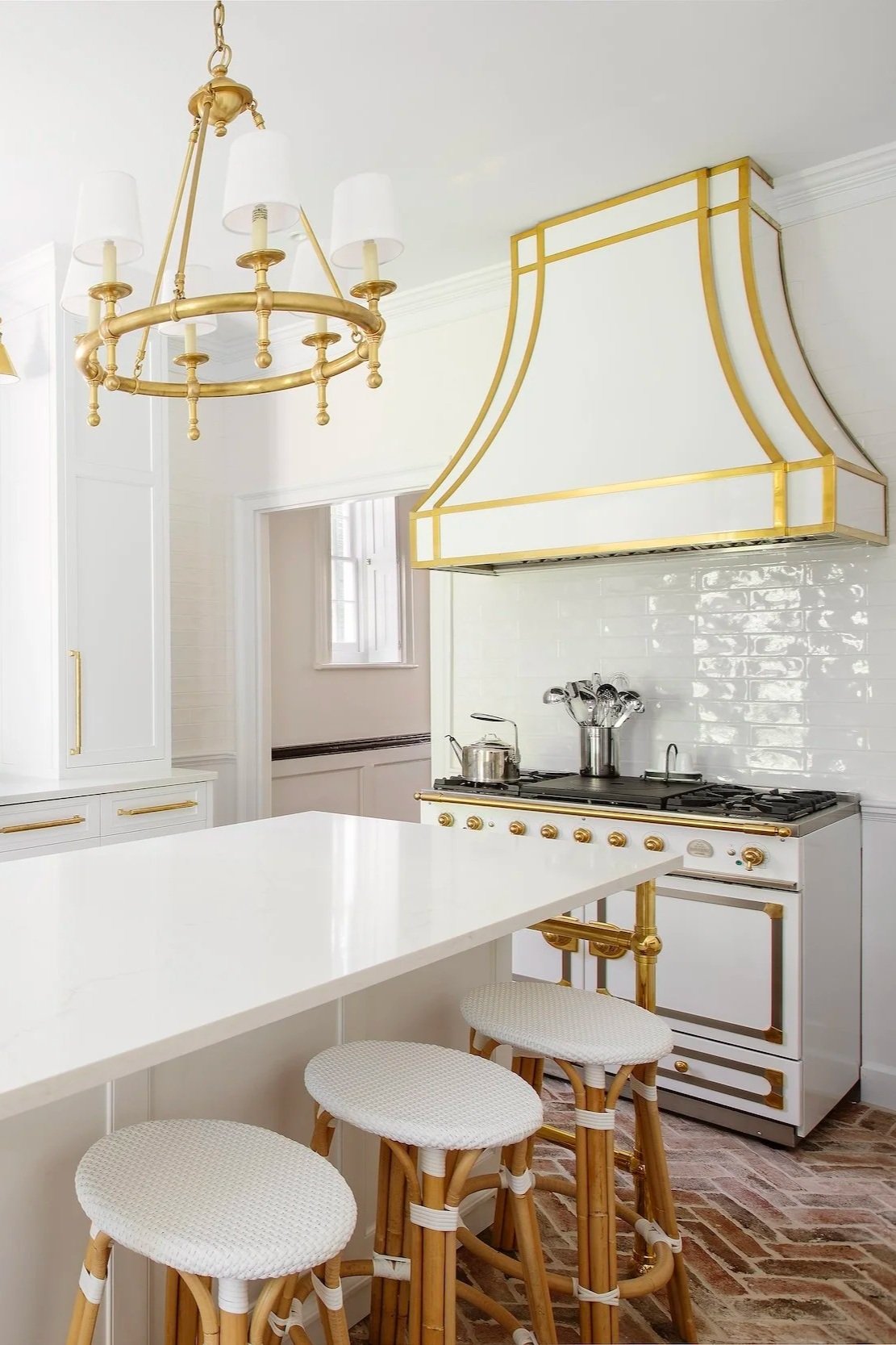Light and airy kitchen with modern, luxury appliances and custom oven and range.