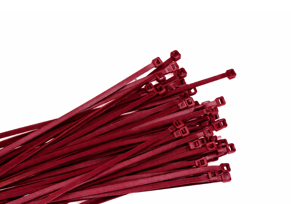 A bunch of red zip ties, arranged on a white background.