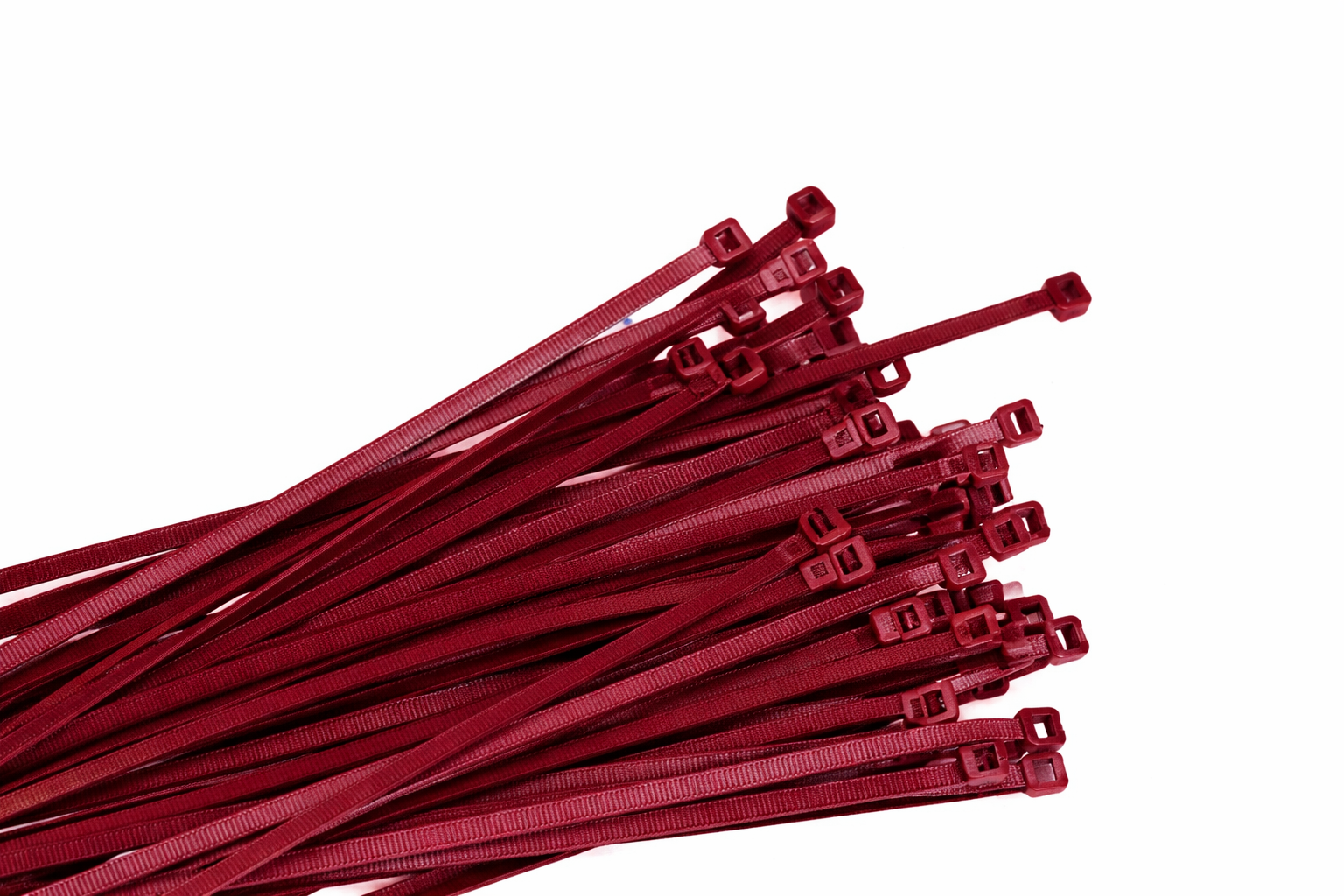 A bunch of red zip ties, arranged on a white background.