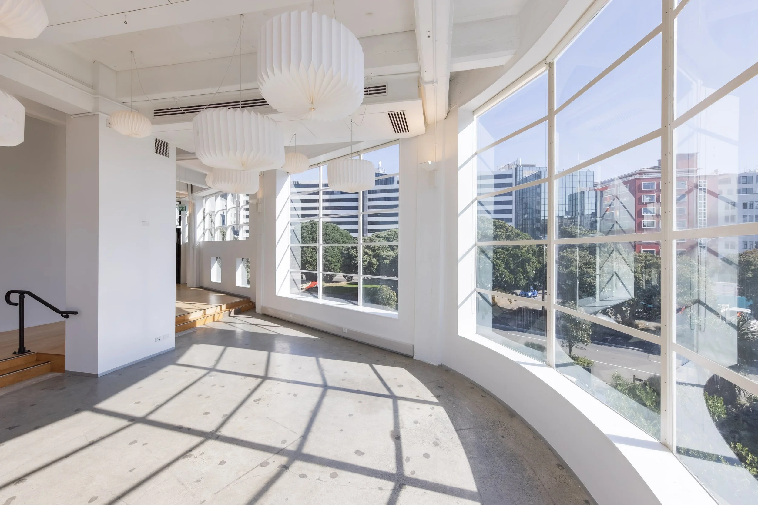 Tūpaia ki Te Aro, a wide view looking out the windows from the level 2 space, over looks city view.