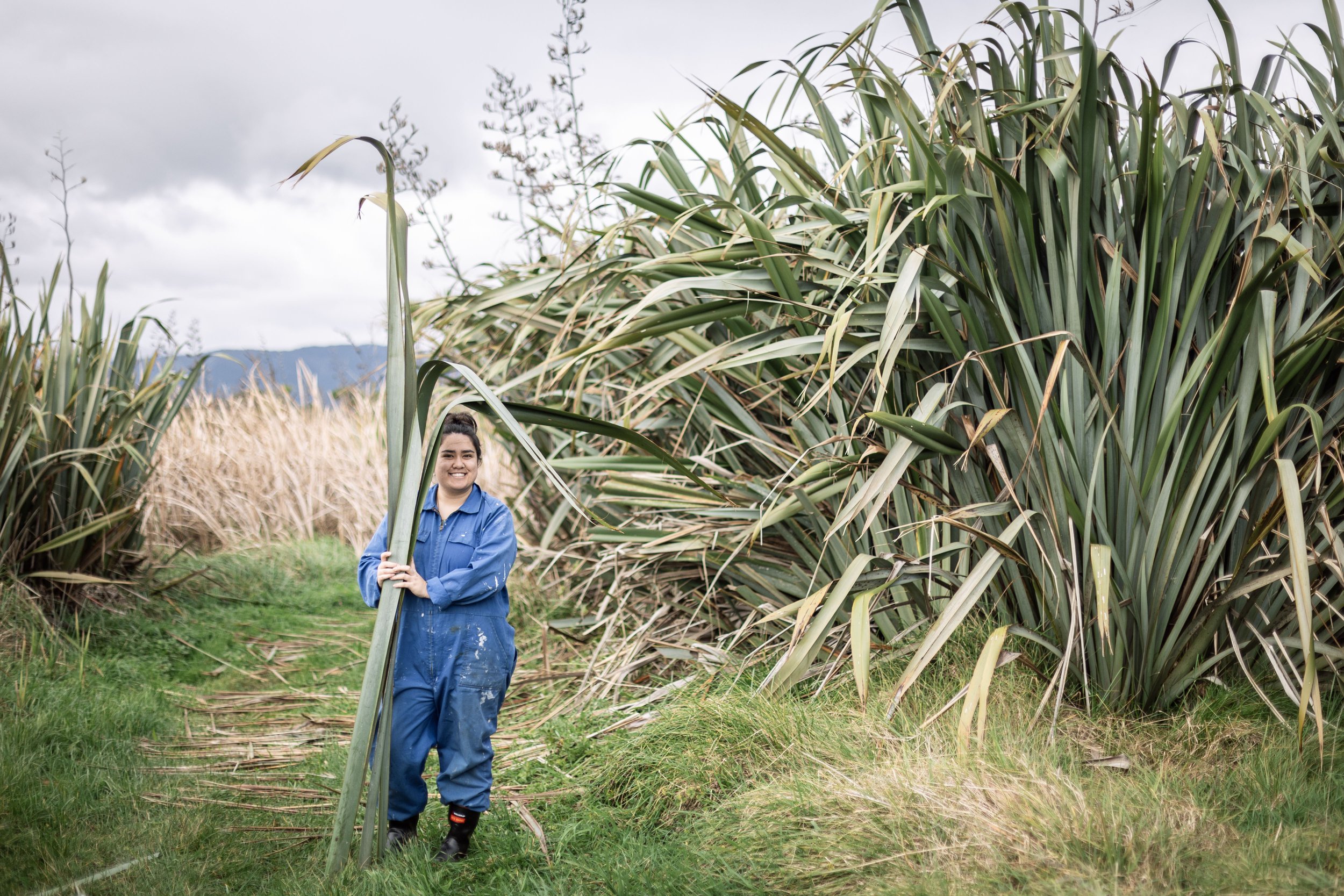 Elena Rei standing near some flax bushes