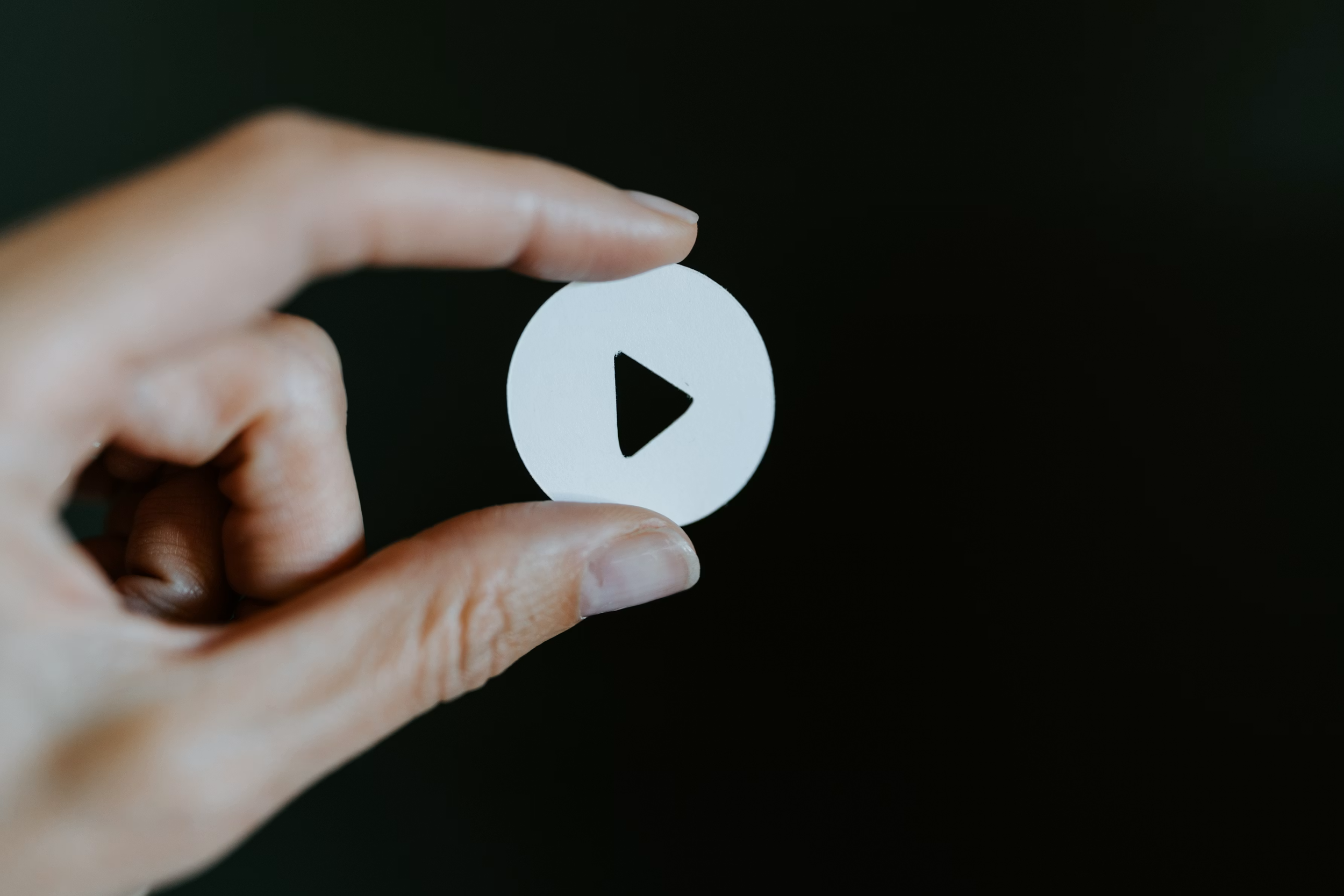 Graphic-of-a-play-head-button-for-a-Toi-Poneke-video.png