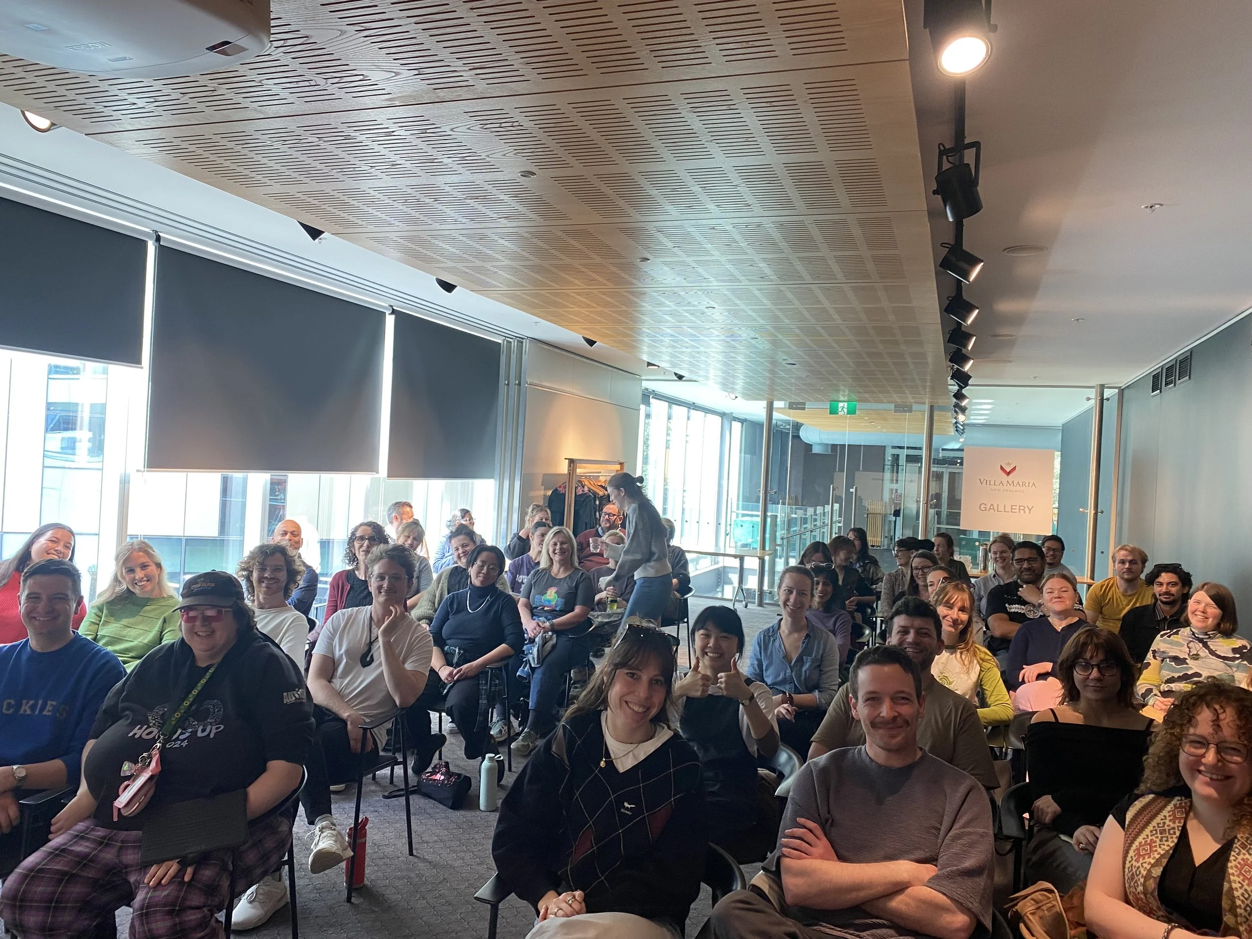 A room of smiling faces at Auckland Theatre Company front of House Accessibility training