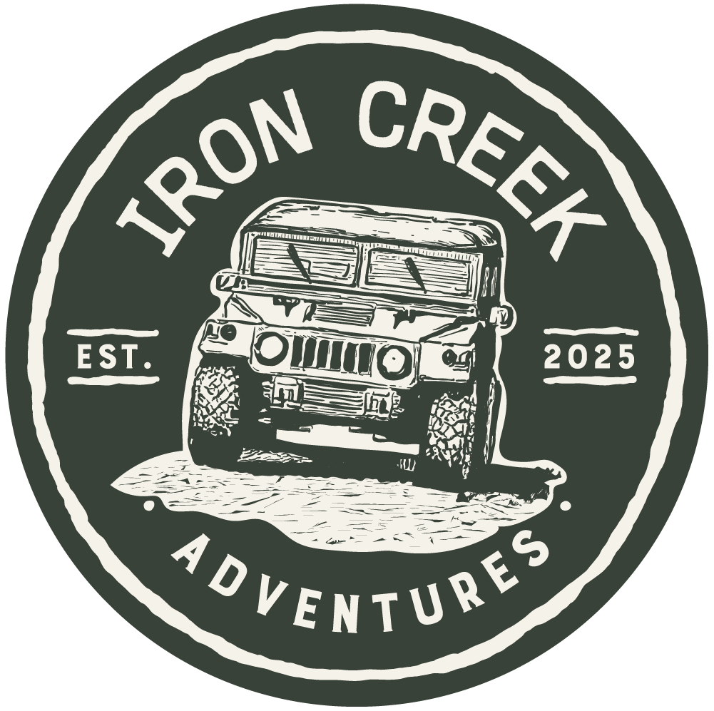 A circular logo for Iron Creek Adventures featuring a black and white illustration of an off-road vehicle driving through a rugged terrain. The text includes 'Iron Creek,' 'Est. 2025,' and 'Adventures'.