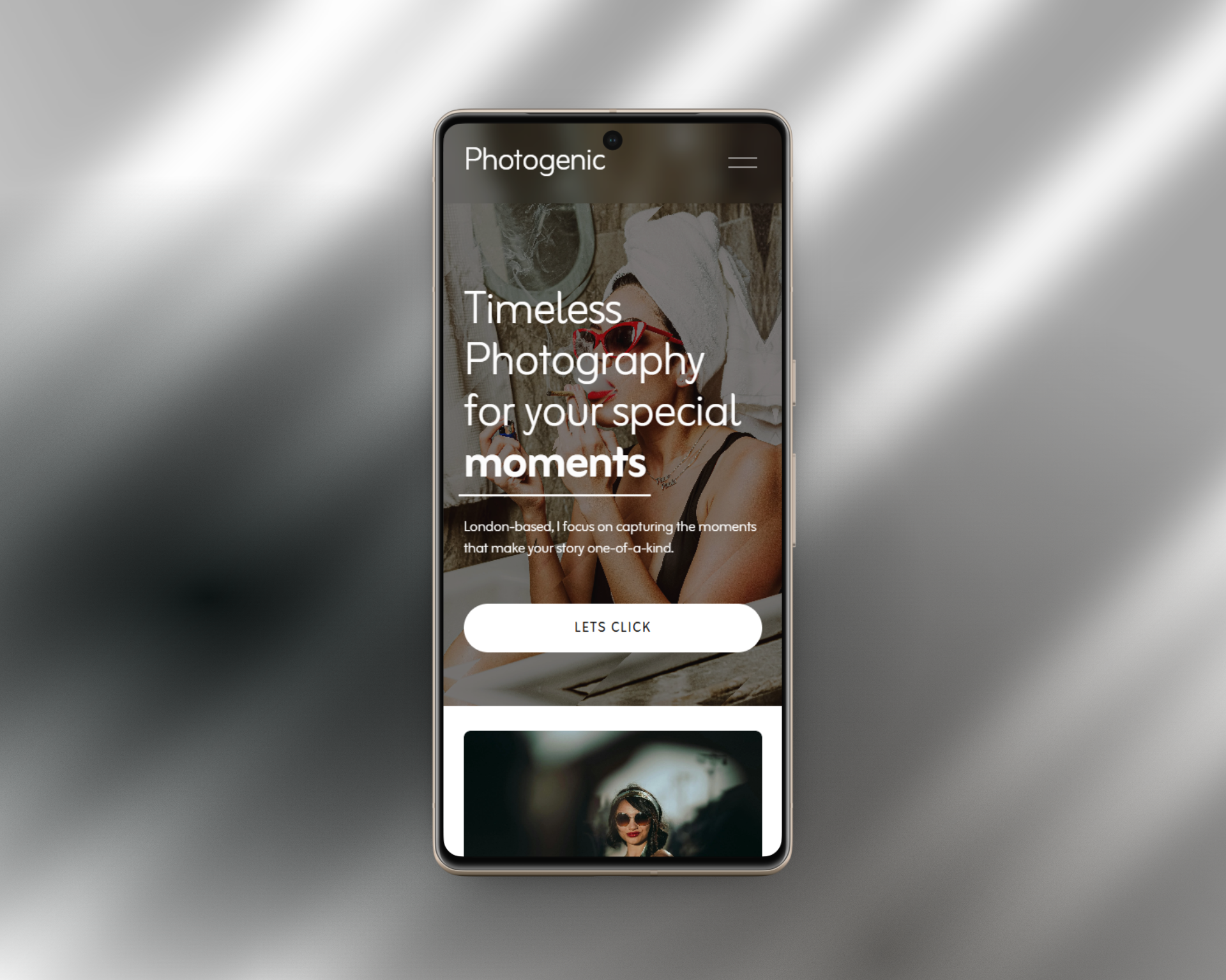 Smartphone displaying a photography app with the text "Timeless Photography for your special moments" over an image of a woman with a towel on her head, wearing glasses, and talking on the phone.