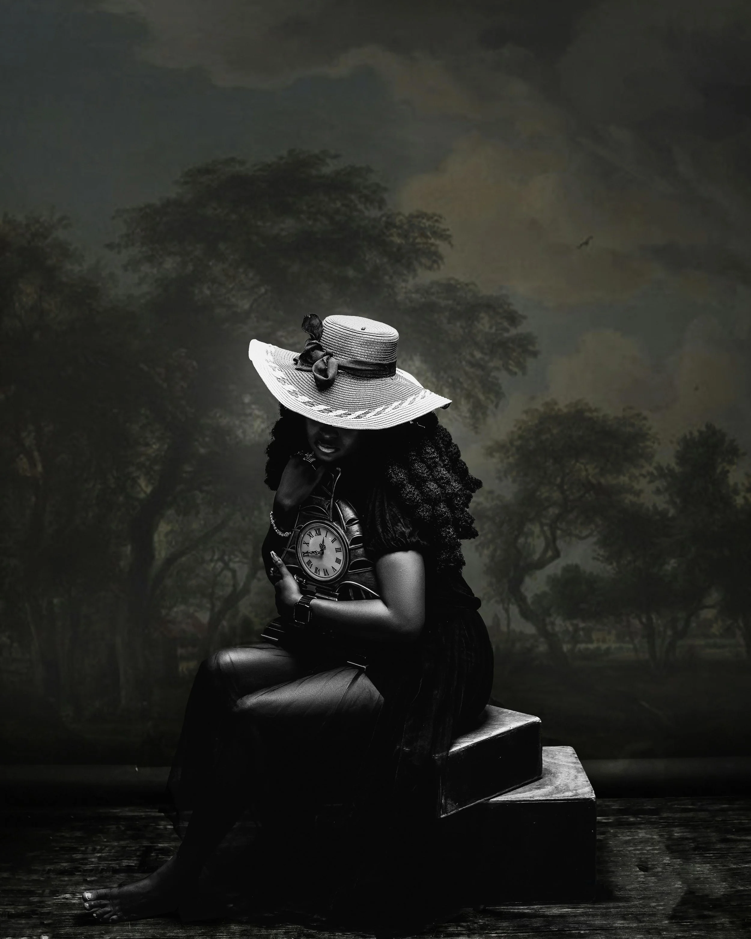 A woman sitting on a wooden bench in a dark outdoor setting at night, wearing a large-brimmed straw hat with a bow, holding a pocket watch, with trees and a bird in the background.