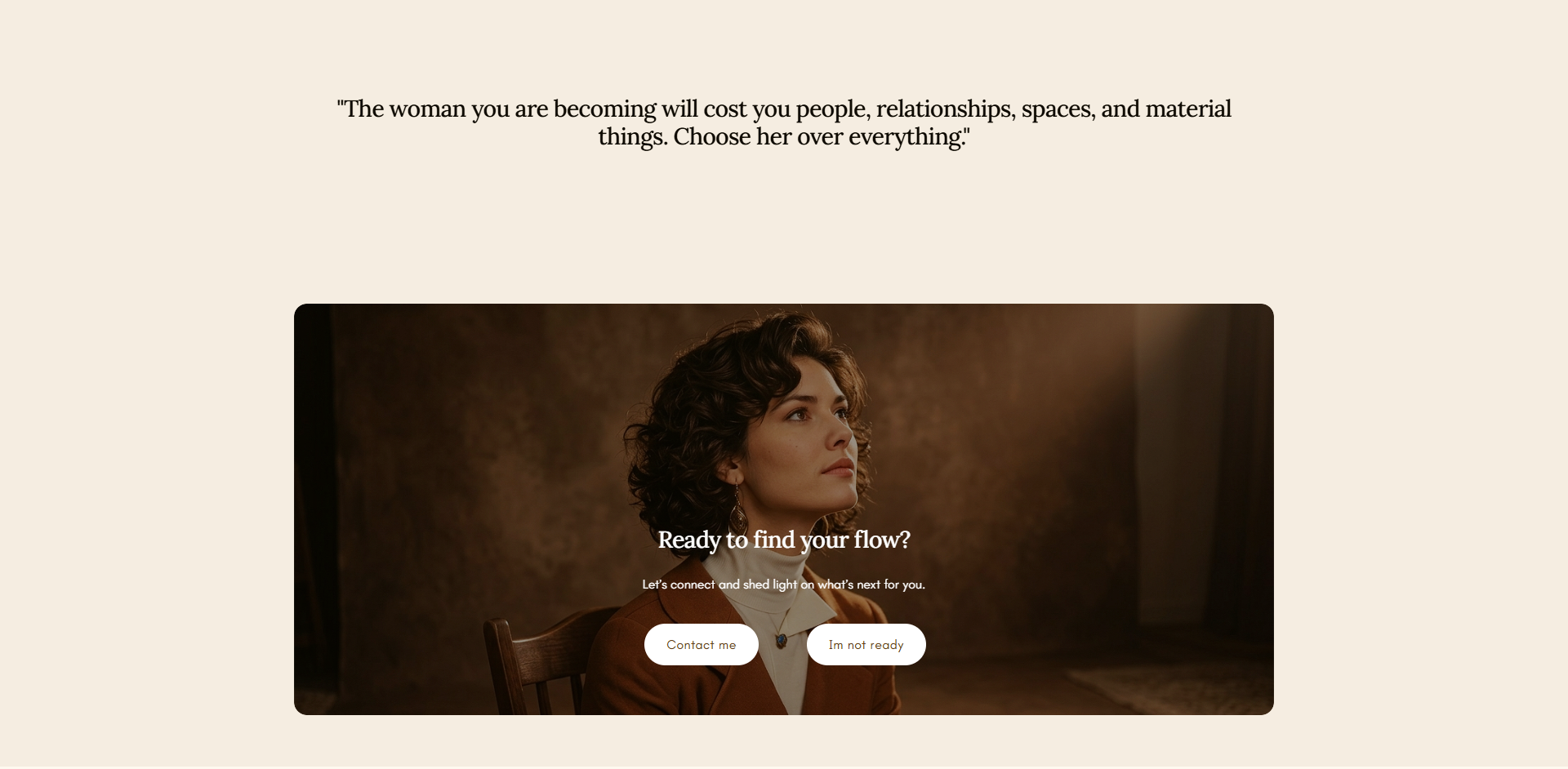 A woman with curly hair, wearing a brown blazer and white turtleneck, seated in a dimly lit room, looking thoughtfully to the side.