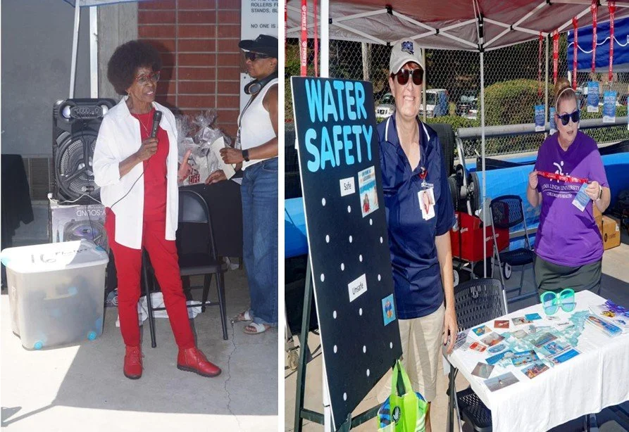 Two women standing at booths outdoors; the left woman speaks into a microphone, the right woman stands near a water safety informational display with smile, wearing sunglasses, and another woman in a purple shirt with sunglasses at the table.
