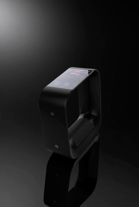 A sleek, black, modern device with a curved transparent screen on top, placed on a dark reflective surface against a black background.