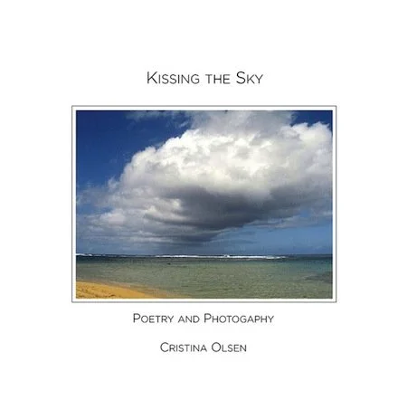 Book cover titled 'Kissing the Sky' with a photo of a cloudy sky over the ocean.