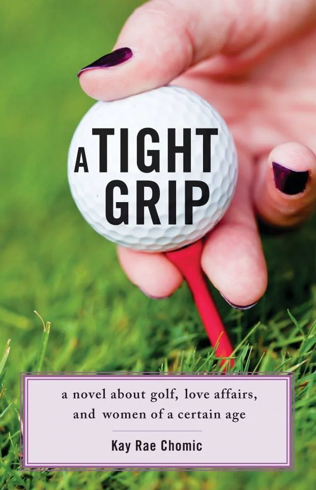 Close-up of a hand holding a golf ball on a tee with the words 'A TIGHT GRIP' written on it. Grass in the background. The book title and author are at the bottom with a purple border.