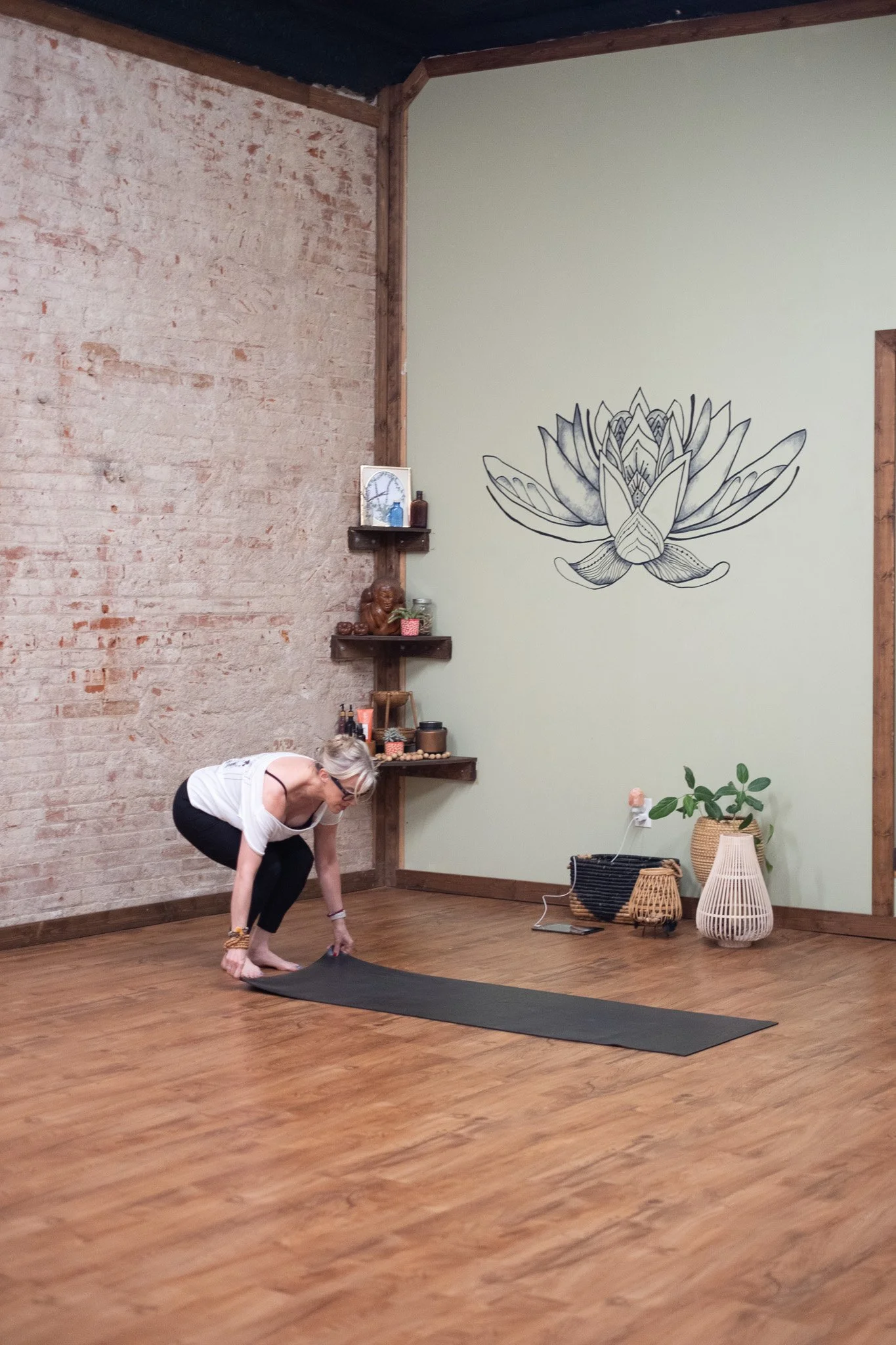 Angie laying down her yoga mat