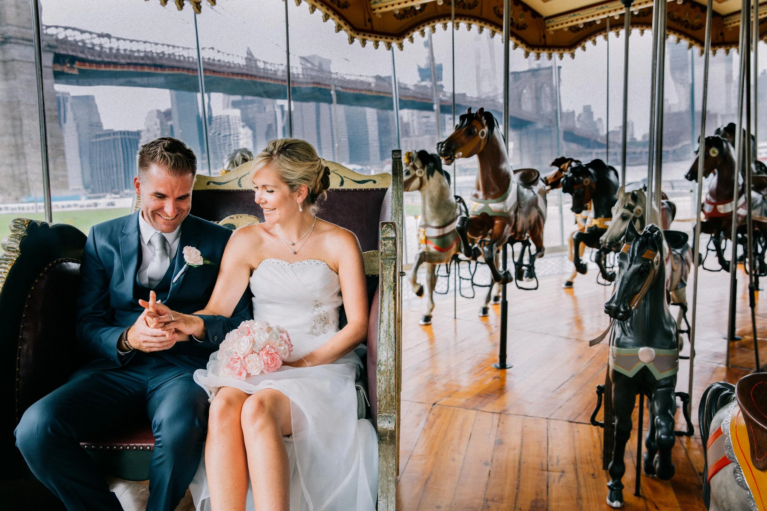 Wedding couple on carousel in downtown manhattan