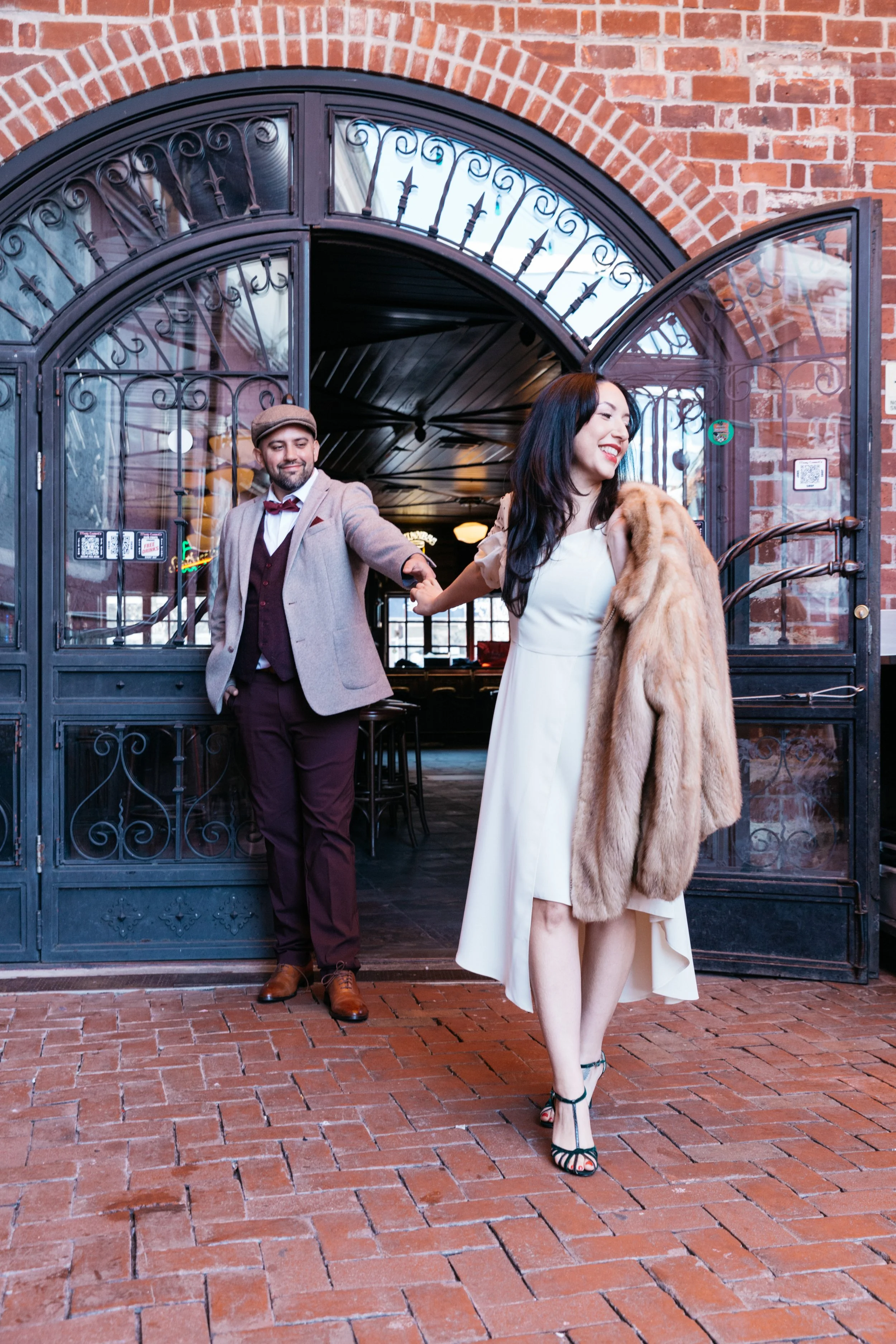 engagement photography of woman leading man by the hand