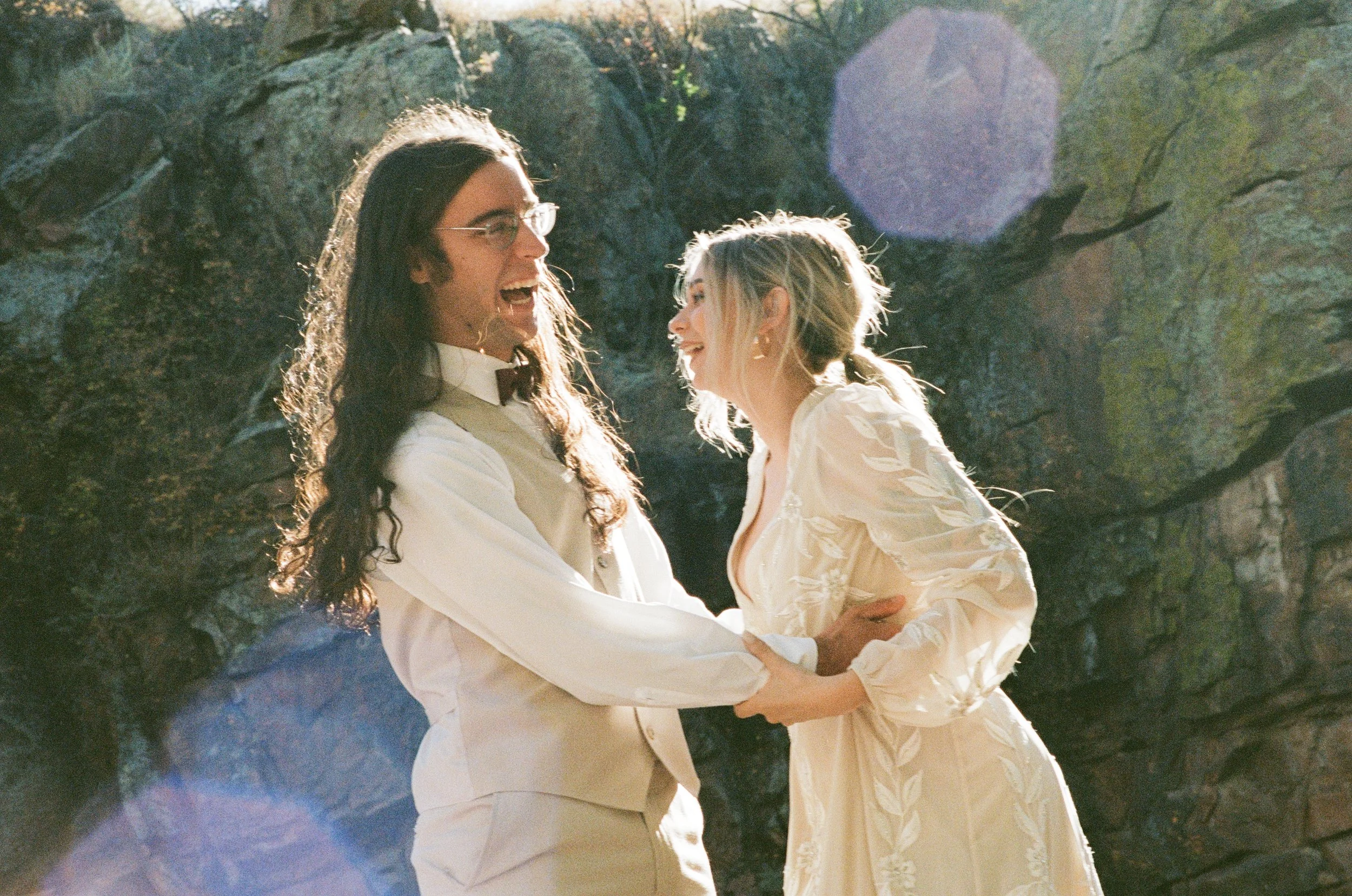 candid moment of wedding couple laughing