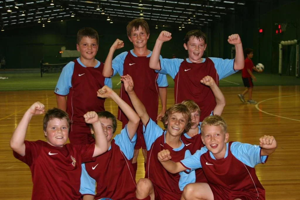 Soccer coach working with young players during a training session in Melbourne