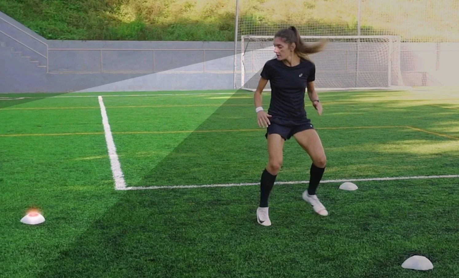 Young soccer player scanning the field before receiving the ball during a private coaching session