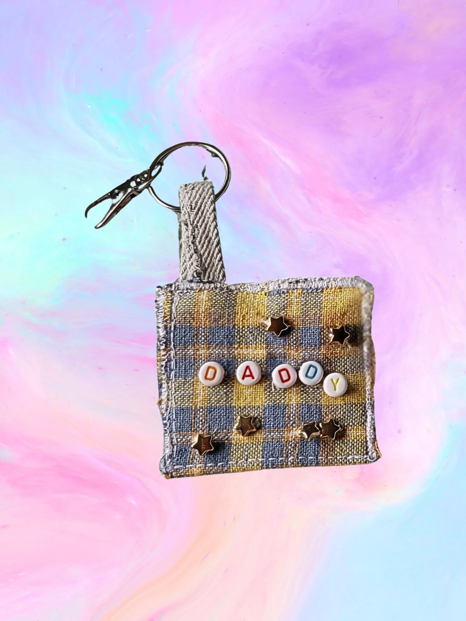 yellow and blue plaid keyring in a square shape with colourful beaded letters that spell out the word 'daddy'