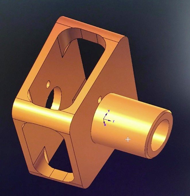 3D rendered metallic mechanical component with a cylindrical protrusion and a hollow interior, shown in gold color against a dark background.