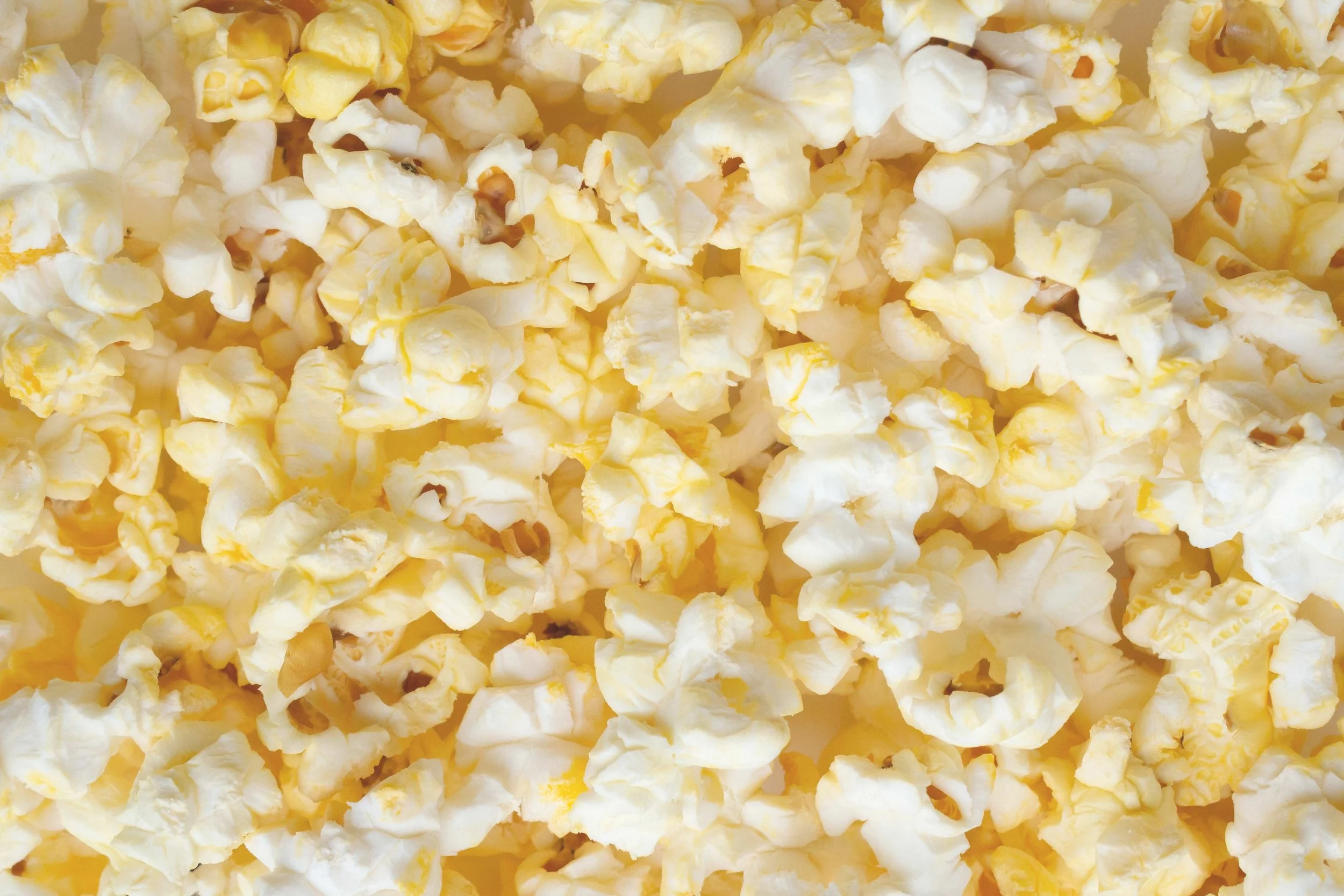 Close-up of freshly popped yellow and white popcorn.