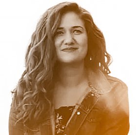 Black and white portrait of a woman with long wavy hair, wearing a leather jacket.