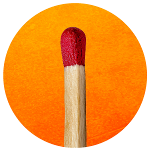 A matchstick with a red head and a wooden stick, standing against an orange background.