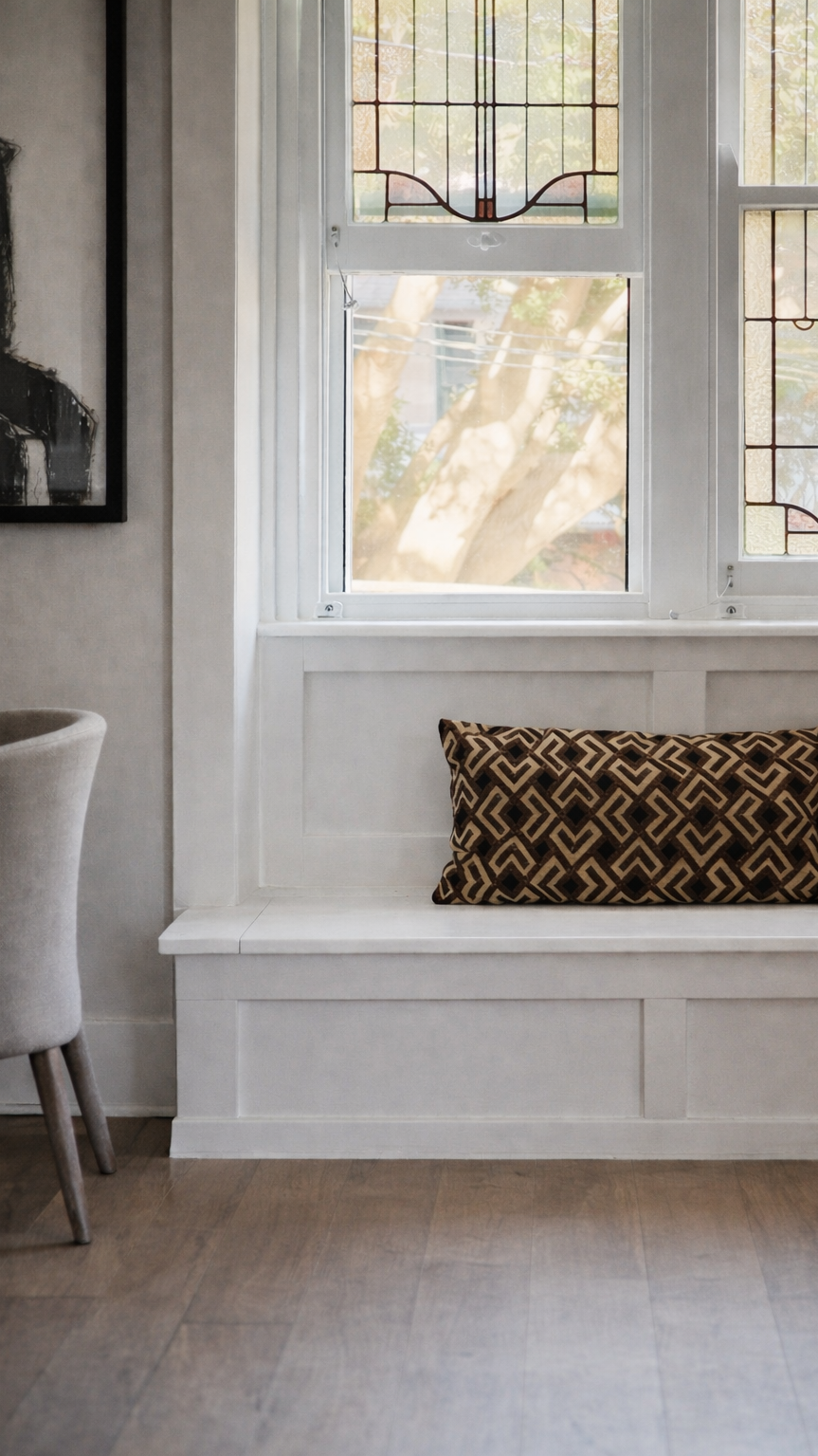 Original Art Deco windows and built-in seating in a renovated Randwick apartment.