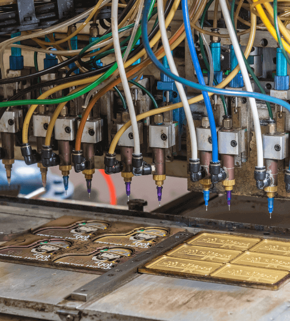 Industrial printing machine with multiple colorful ink tubes above printing plates.