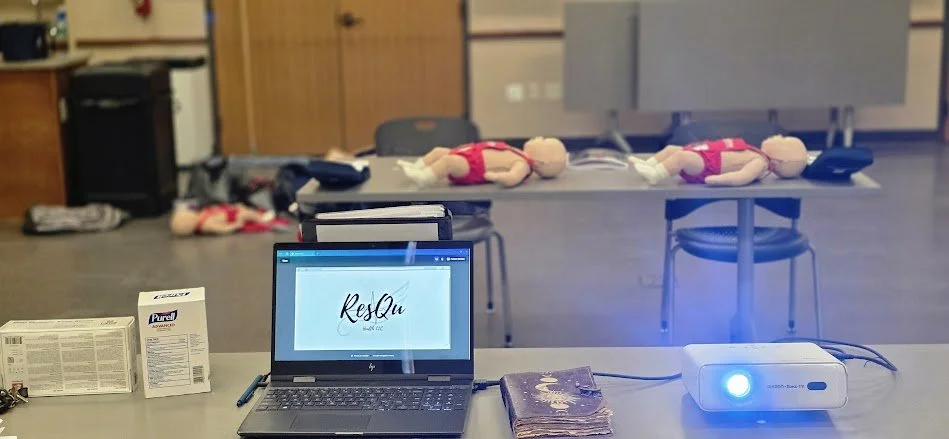 ResQu Health showing view from the instructor. Infant mannikins scatter the background. Teaching is happening and it is lit