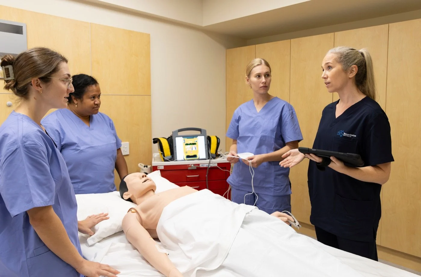 EMRT instructors running a hands-on ALS simulation with a training manikin