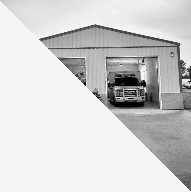 A large garage with a pickup truck inside, partially visible through a tall open door.