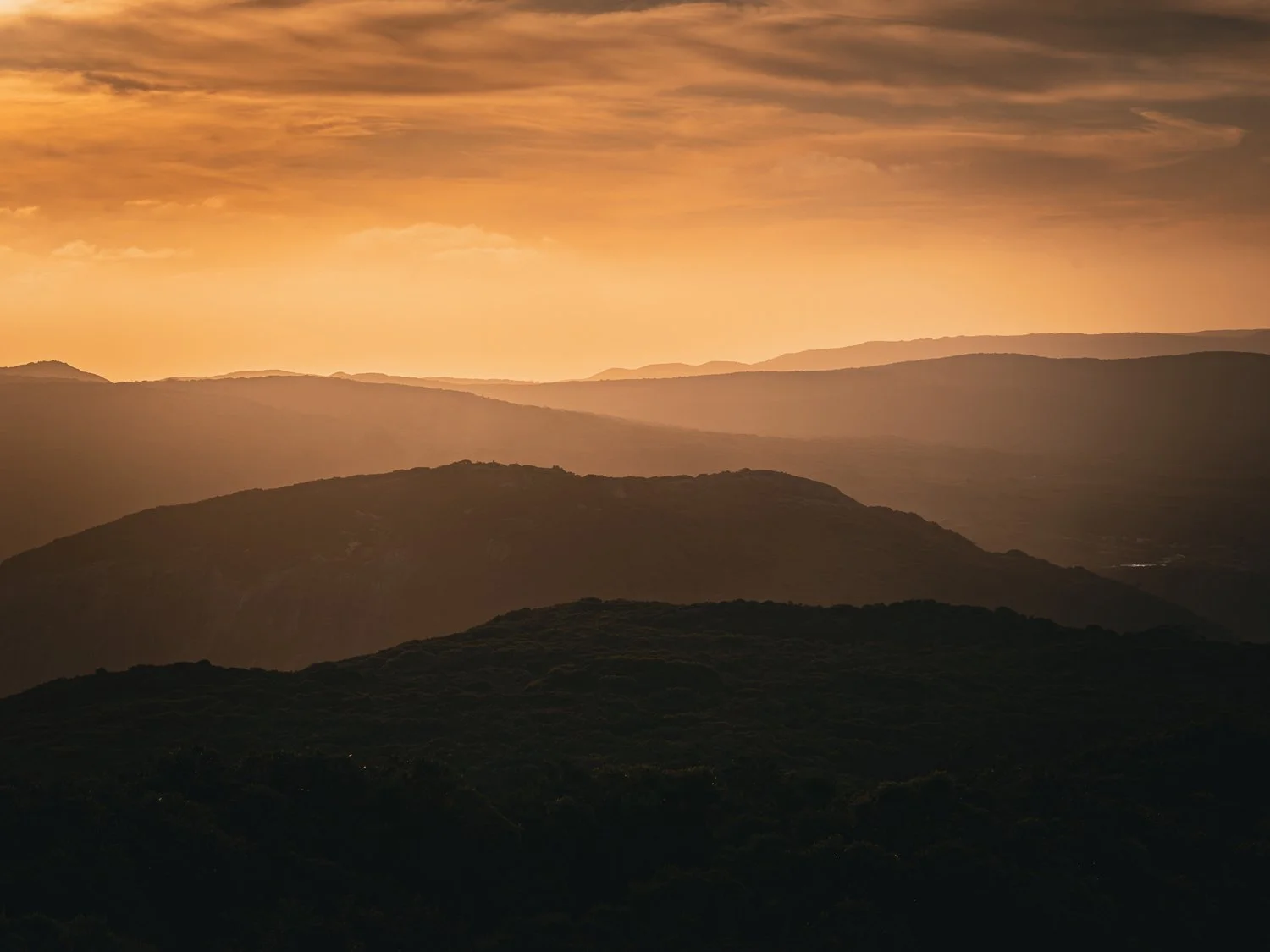Layered mountain ridges within the Porongurup Range illuminated by warm evening light.
