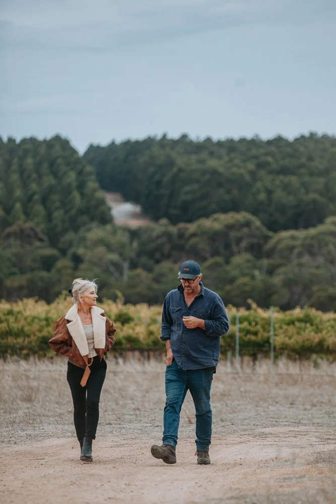 Great Southern Sip founder walking with a local wine producer through a Great Southern vineyard.