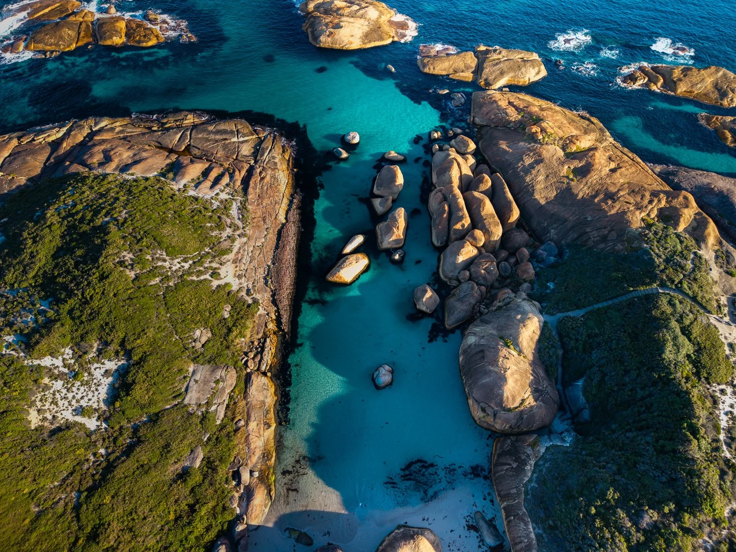 Aerial view of turquoise water and granite formations at Elephant Rocks near Denmark.