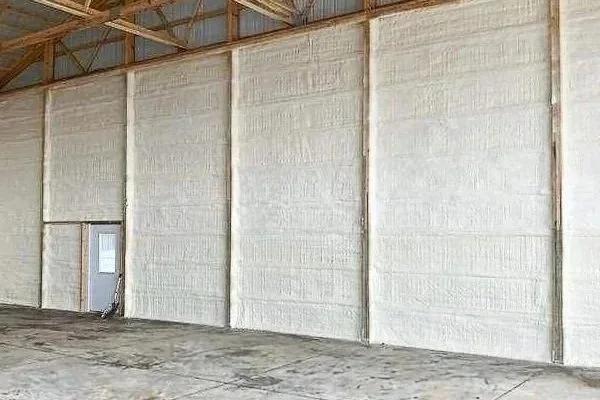 Interior of a warehouse with unfinished walls and a concrete floor.