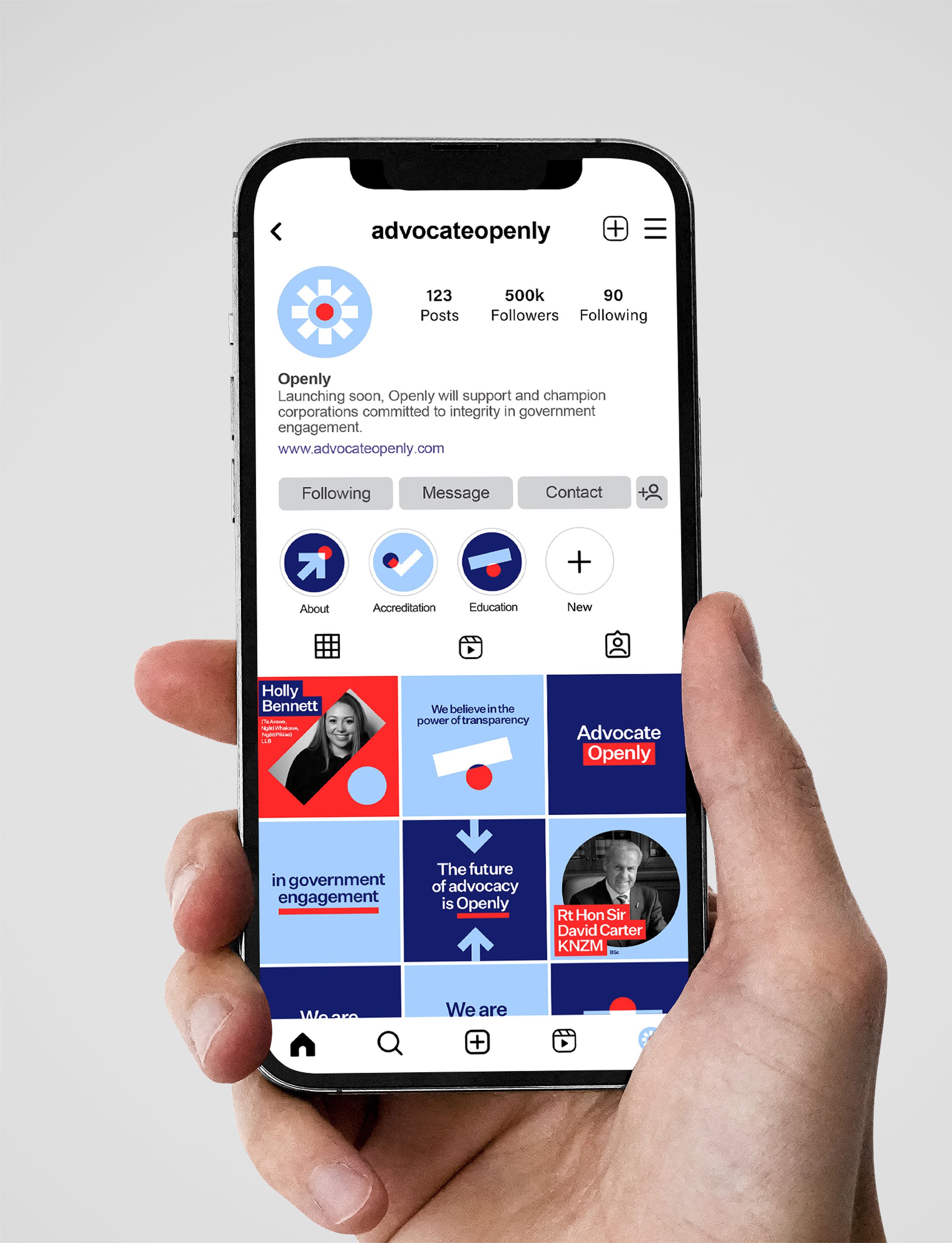 A hand holding a smartphone displaying an Instagram profile page for advocateopenly, with posts about government engagement and advocacy.