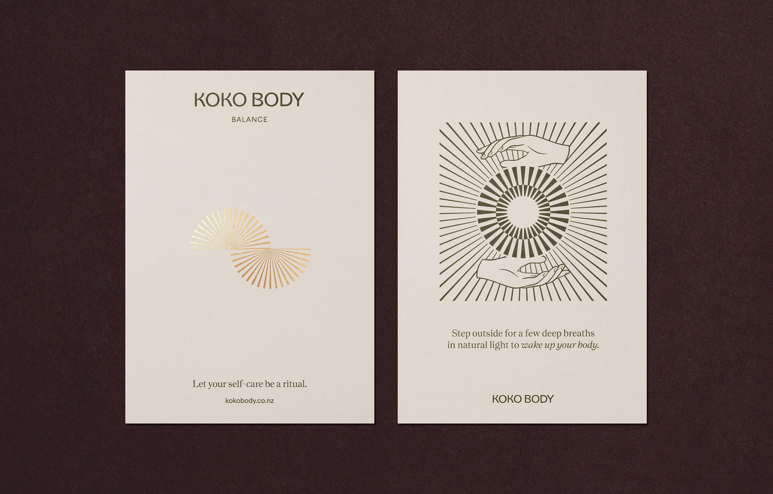 Two minimalistic cards with black and gold designs from KOKO BODY, featuring line art and calming messages about self-care and deep breaths, placed on a dark background.
