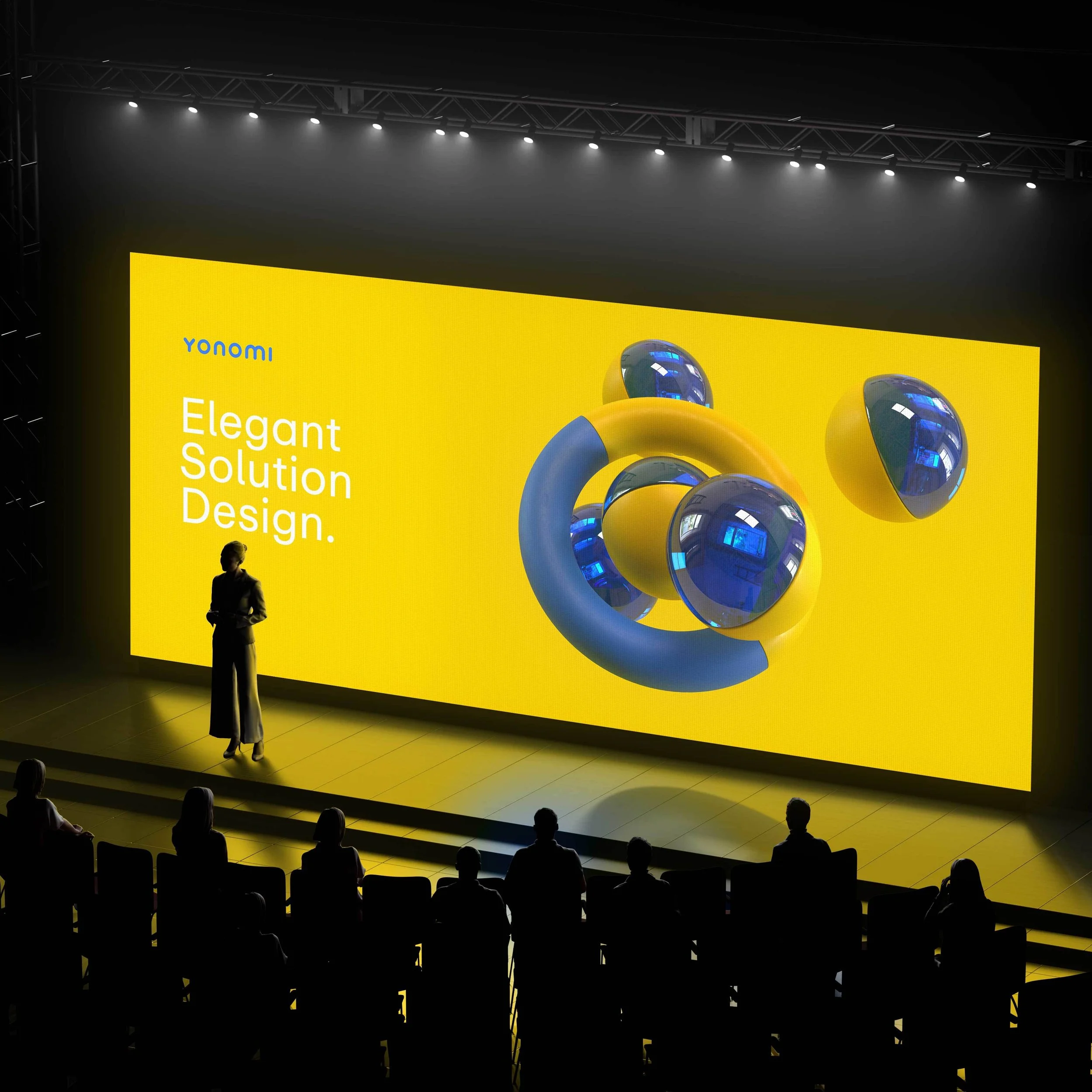 A presentation slide on a large yellow screen featuring a blue and yellow abstract 3D design. The slide has the text 'Yonomi' in blue, and 'Elegant Solution Design' in white. A woman presenter stands in front of the screen on a stage, addressing an audience seated in front.