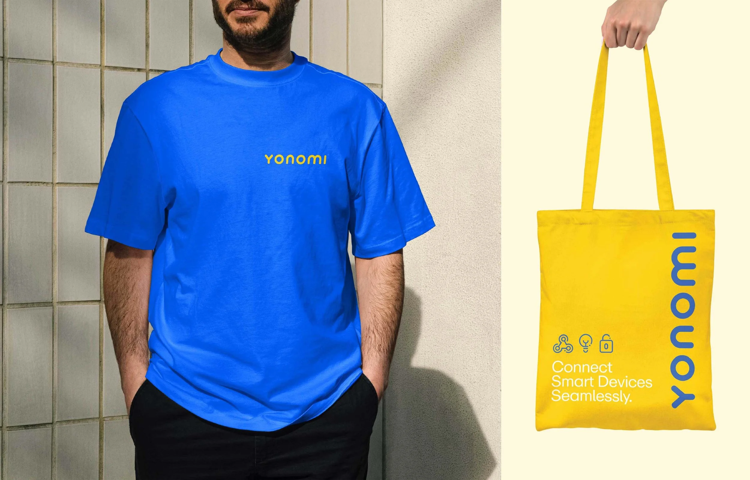 A man wearing a blue T-shirt with the yellow logo 'yonomi' stands against a tiled wall, and a yellow bag with the same logo and icons reading 'Connect Smart Devices Seamlessly' is displayed next to him.
