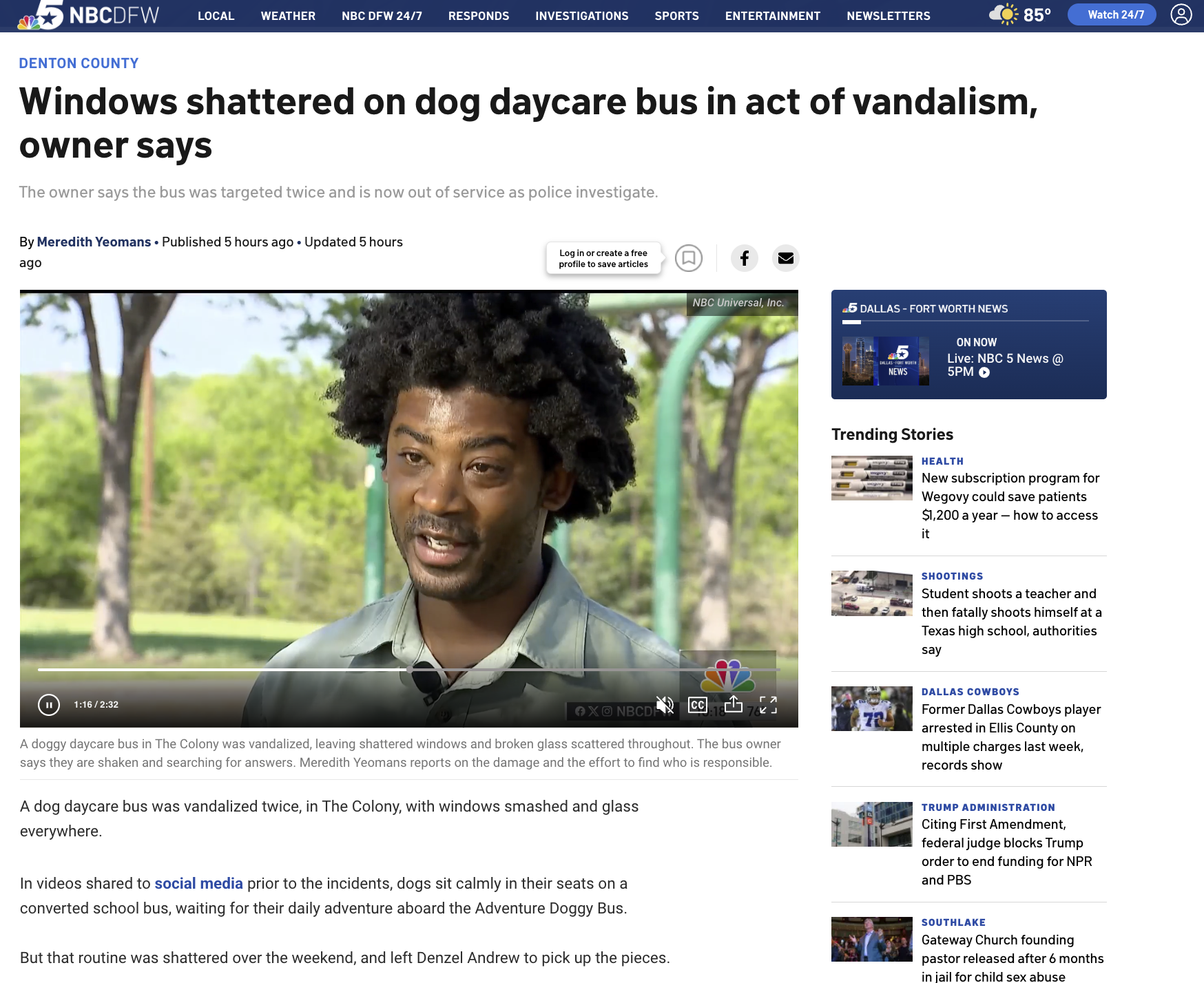 A man with natural black curly hair and a beard being interviewed outdoors with trees and a green playground structure in the background.